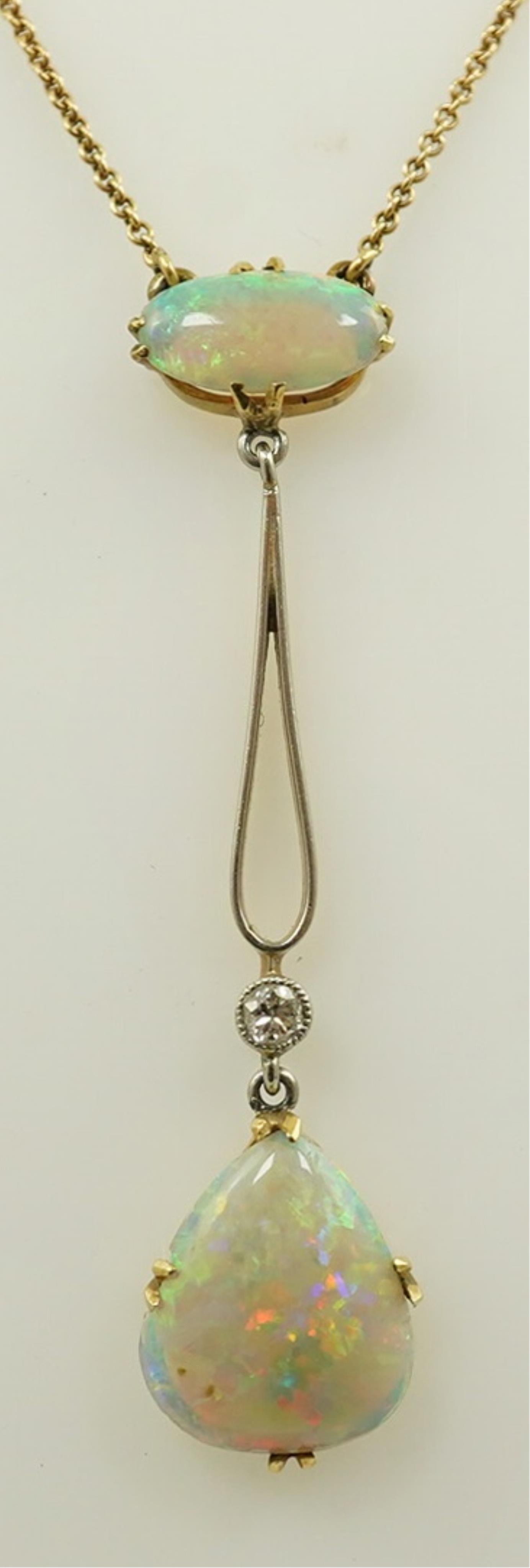 An early 20th century gold, two stone white opal and single stone diamond set drop pendant necklace